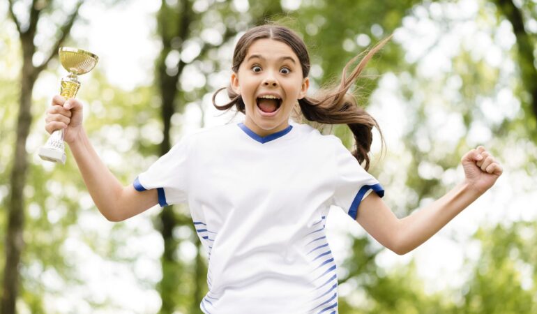 Adj_little-girl-jumping-after-winning-football-match